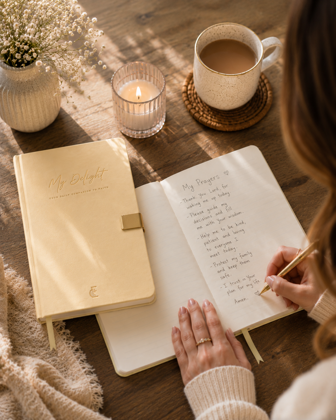 Writing prayers in an open My Delight journal with coffee